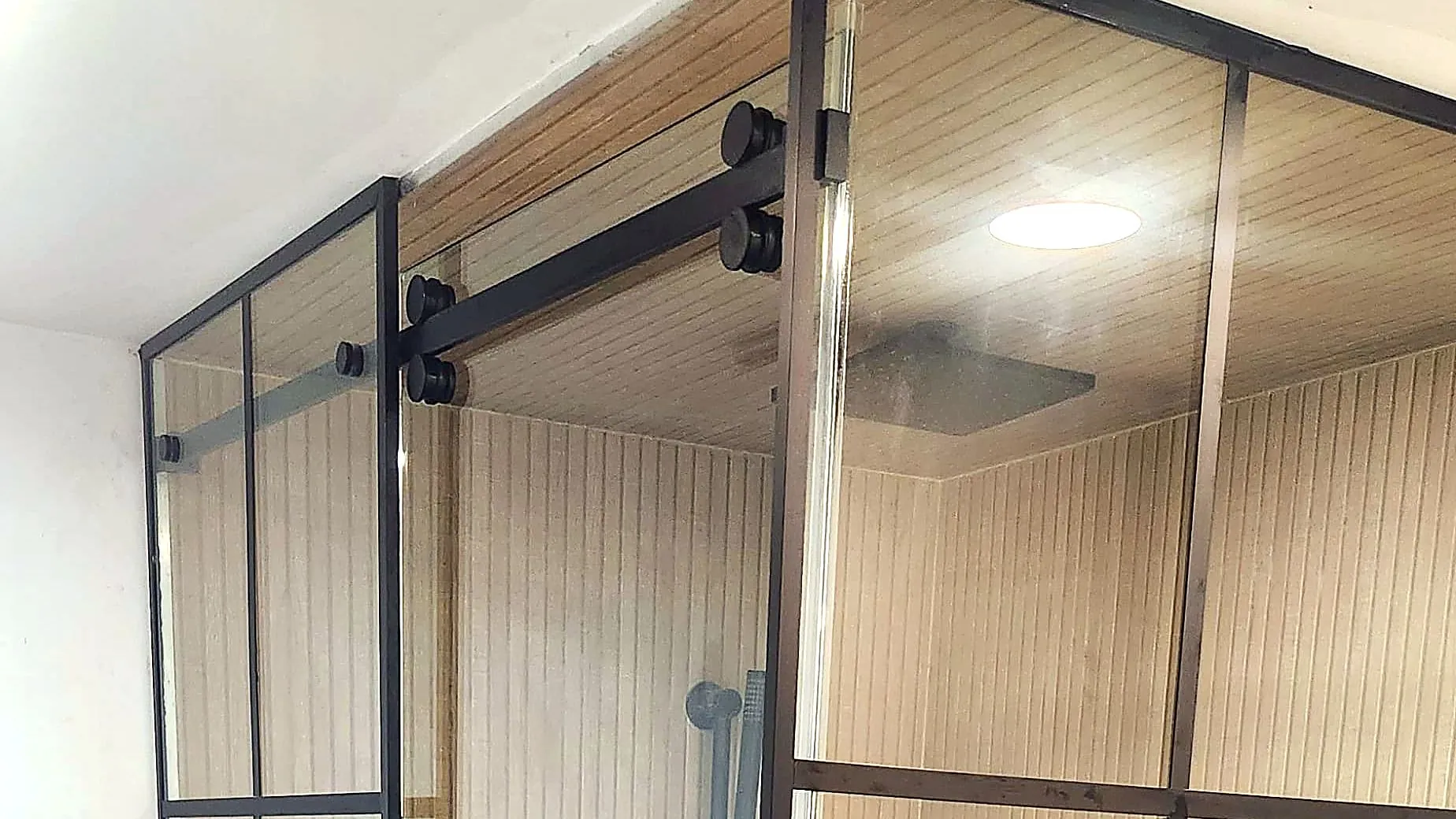 Black grid-framed glass shower enclosure