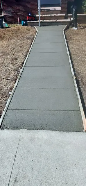 Fresh concrete walkway leading to front steps